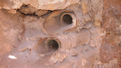 Clay central heating pipes built into the wall.